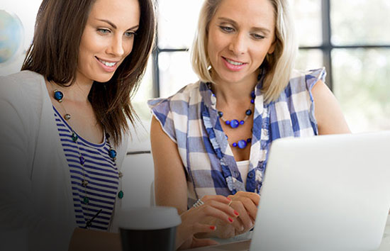 Two Women Sitting at a Computer